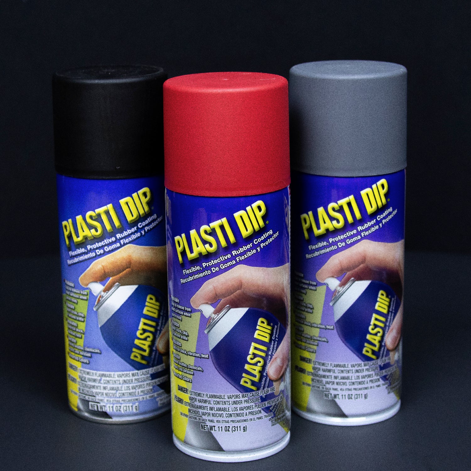 Car rim next to can of black Plasti Dip, aerosol rubber coating 